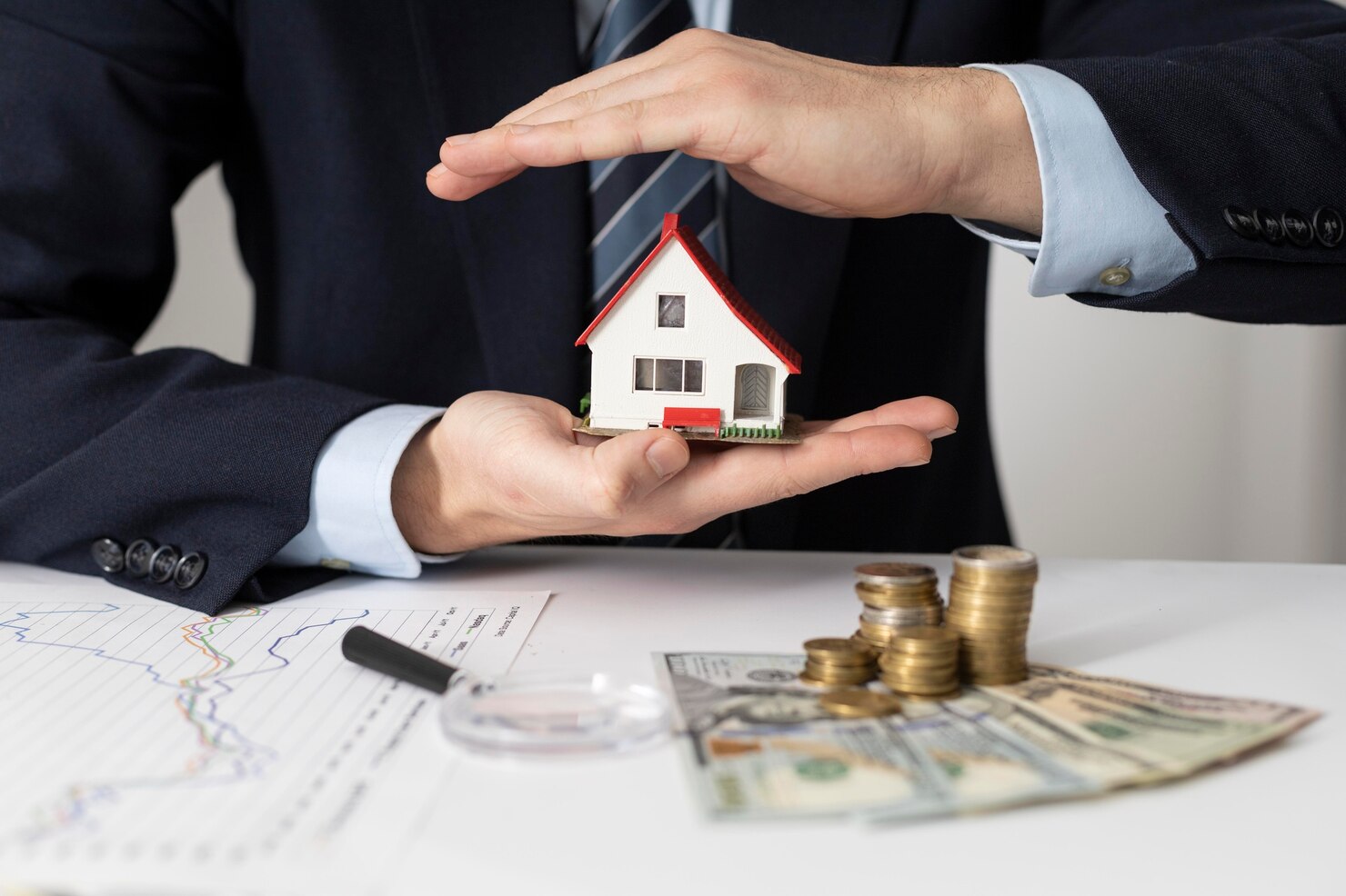 Home loan in Pune with miniature house model, financial charts, and savings, illustrating mortgage financing and property purchase assistance.